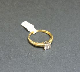 An 18ct gold four stone princess cut diamond square cluster ring