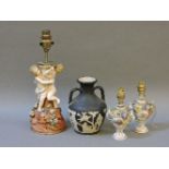 A pair of Dresden vase form table lamps, a German centrepiece, and a Wedgwood Portland vase
