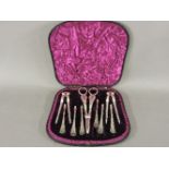 A cased Victorian silver plated set, including grape scissors and nut crackers