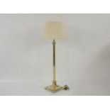 An Edwardian brass corinthian column standard lamp, with pleated shade