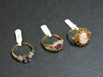 A 9ct gold synthetic ruby and diamond ring, a 9ct gold carved shell cameo ring, and a 9ct gold