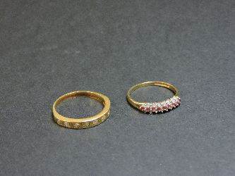 A diamond set half eternity ring, tested as approximately 18ct gold, and a 9ct gold ruby and diamond