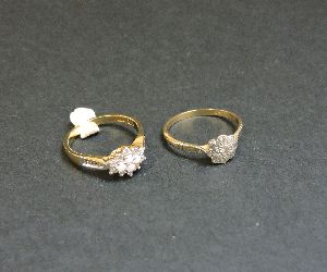 A diamond set daisy cluster ring, marked 9ct, and a 9ct gold opal and diamond lozenge shaped cluster