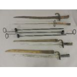 Three late 19th century bayonets, two with scabbards, and a Ponyard and three stands