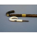A Brigg walking cane, with 9ct gold mount and short pencil, 97cm long, and a Japanese ivory