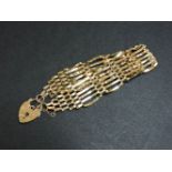 A 9ct gold seven row gate bracelet