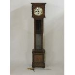 An oak grandmother clock, the three main movement striking the hours and half hours on gong