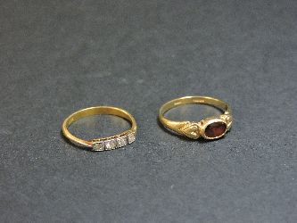 A 9ct gold garnet ring, and an Art Deco four stone diamond ring marked 18ct