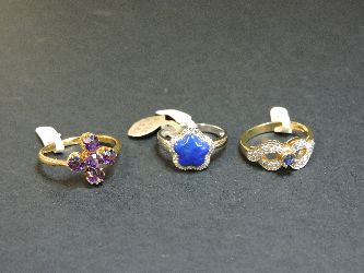 A 9ct gold sapphire and diamond ring, a 9ct white gold lapis lazuli and diamond cinquefoil cluster