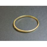 A 9ct gold hinged bangle