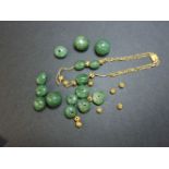 An aventurine quartz bead necklace or bracelet, with pierced gold beads and chain back, tested as