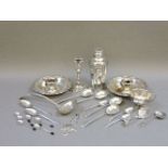 A quantity of silver plate and silver, including a silver candlestick, coffee bean teaspoons, and