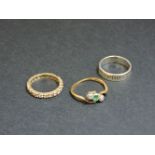 A gold synthetic spinel full eternity ring, marked 9ct, an emerald and diamond three stone ring