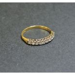 An 18ct gold diamond set half eternity ring