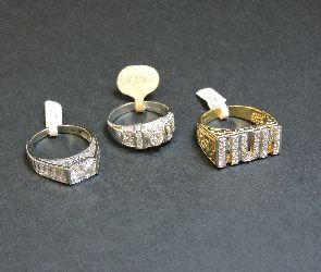 A 9ct gold cubic zirconia set 'MUM' ring, and two 9ct white gold cubic zirconia rings