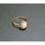 An opal and diamond oval cluster ring, marked 18ct plat, finger size R
