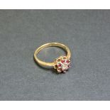 A 9ct gold diamond and ruby cluster ring