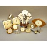 An Art Deco style lamp, a quantity of travelling clocks, a chess clock, and other items
