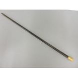 A gold topped ebony cane, with engraved and chased detail, tested as approximately 18ct gold, damage