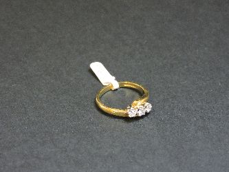 An 18ct yellow and white gold three stone diamond crossover ring