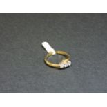An 18ct yellow and white gold three stone diamond crossover ring