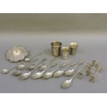 A German silver tea strainer, three matching German silver knife rests, three Continental silver