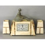 An Art Deco marble mantel clock garniture, surmounted with a lady, with a rectangular dial