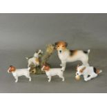 A Royal Doulton puppy, two Beswick Jack Russells, and two others