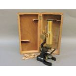 A brass monocular microscope and slides