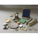 A strawberry dish, two silver mounted brushes, a silver clock, a silver photograph frame, a