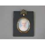 A mid 19th century miniature of a young child, painted by William Eply, in an ebony style frame