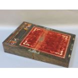 A Victorian rosewood and mother of pearl inlaid writing box, opening to reveal a red velvet and gilt