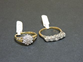 A five stone diamond ring, marked 18ct plat, and an 18ct gold diamond set cluster ring