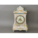 A late 19th/early 20th century porcelain mantel clock, with French drum movement, striking on a