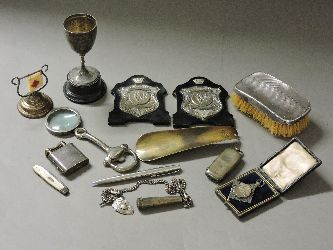 Various small silver items, including a cup, cigarette holder on chain, folding fruit knife, etc