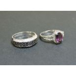 A 9ct white gold black and white diamond ring, and a 9ct white gold garnet and diamond ring