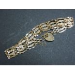 A 9ct gold four row crimped link gate bracelet