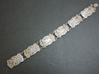 A Danish silver bracelet, by Willy Winnaess, with a series of relief plaques with men on