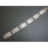 A Danish silver bracelet, by Willy Winnaess, with a series of relief plaques with men on