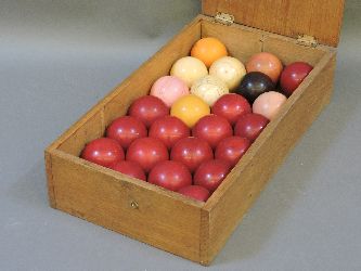 A Victorian set of twenty-four ivory billiard balls, stained and natural