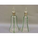 A pair of Liberty style glass decanters, with silver collars