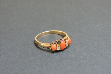 An Edwardian coral and diamond seven stone ring, one diamond deficient, tested as approximately