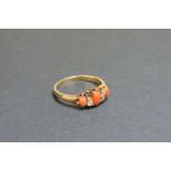 An Edwardian coral and diamond seven stone ring, one diamond deficient, tested as approximately