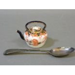 A Royal Crown Derby miniature kettle, and a George III silver spoon
