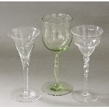 Three Whitefriars glasses, designed by Harry Powell, circa 1890-1900, two with a green tint, tallest