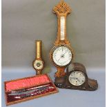 An oak cased aneroid barometer, another, a Westminster chiming mantel clock, and a three piece