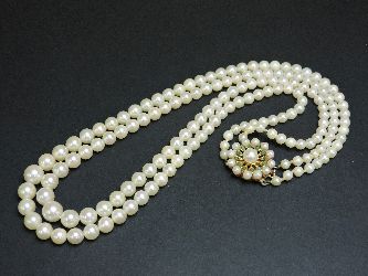 A two row cultured pearl necklace, with a cultured pearl and turquoise set clasp marked 9ct