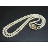 A two row cultured pearl necklace, with a cultured pearl and turquoise set clasp marked 9ct