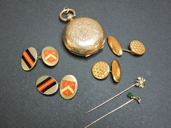 A rolled gold sovereign case, a gold and split pearl stick pin, a gold and jade stick pin, and