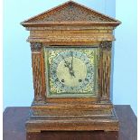 A Victorian oak bracket clock, the silvered dial with black Roman and Arabic numerals, striking on a